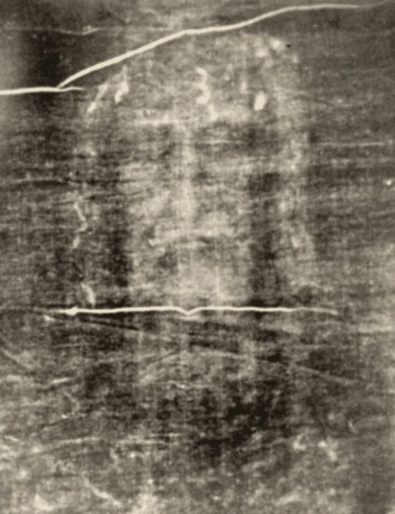 The face on the Shroud of Turin as it appears on a photographic negative: a bearded man with long hair and closed eyes, with blood marks on the forehead
